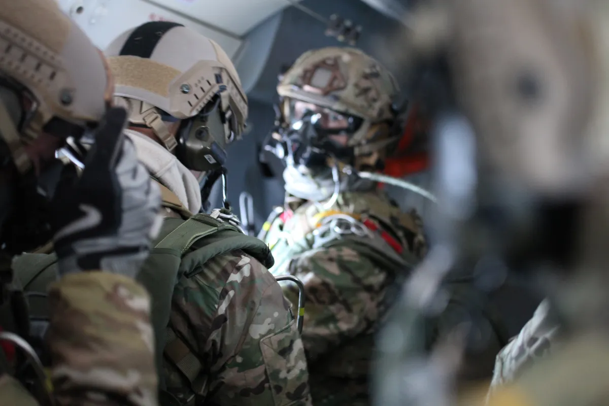 Military veterans in tactical gear preparing for deployment